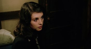 Movie still from “The Driver” (1978), directed by Walter Hill – A woman in a suit and tie looking to her left; Close Up shot, High angle