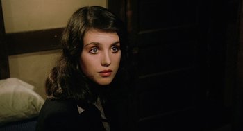Movie still from “The Driver” (1978), directed by Walter Hill – A young woman with dark hair wearing a suit and tie; Close Up shot, High angle