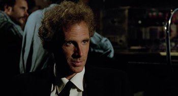 Movie still from “The Driver” (1978), directed by Walter Hill – A person wearing a suit and tie; Close Up shot, Over the shoulder angle