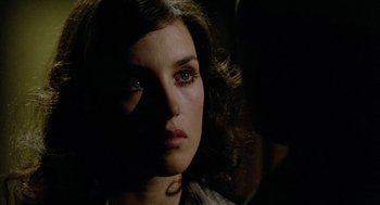 Movie still from “The Driver” (1978), directed by Walter Hill – A person's face in the dark; Close Up shot, Over the shoulder angle