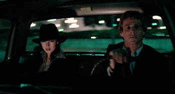 Movie still from “The Driver” (1978), directed by Walter Hill – A man and a woman sitting in the back of a car; Close Up shot, Low angle