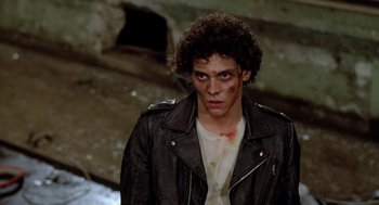 Movie still from “The Driver” (1978), directed by Walter Hill – A young man with blood all over his face; Medium shot, Low angle
