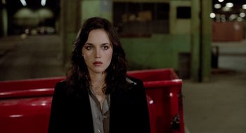 Movie still from “The Driver” (1978), directed by Walter Hill – A woman with long dark hair wearing a black jacket; Close Up shot, High angle