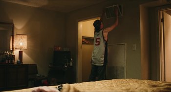 Movie still from “Euphoria” (2019), created by Sam Levinson – A man in white shirt standing next to a bed; Medium shot, Low angle