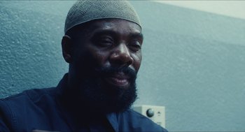 Movie still from “Euphoria” (2019), created by Sam Levinson – A man with a beard wearing a hat and smiling; Close Up shot, Low angle