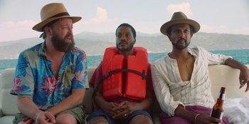 A group of men sitting next to each other on a boat