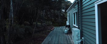 Movie still from “The Dunes” (2021), directed by Martin Copping – A wooden deck in the middle of the night; Extreme Wide shot, High angle