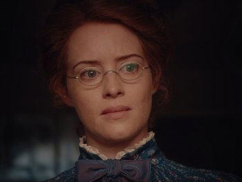Movie still from “The Electrical Life of Louis Wain” (2021), directed by Will Sharpe – A person wearing glasses and a bow tie; Close Up shot, Over the shoulder angle