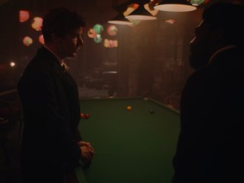 Movie still from “The Electrical Life of Louis Wain” (2021), directed by Will Sharpe – Two men standing in front of a pool table; Medium shot, Over the shoulder angle