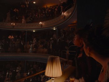 Movie still from “The Electrical Life of Louis Wain” (2021), directed by Will Sharpe – A crowd of people sitting in a theater; Extreme Wide shot, High angle