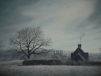 Movie still from “The Electrical Life of Louis Wain” (2021), directed by Will Sharpe – A house with a tree in the background in a snowy field; Extreme Wide shot, Low angle