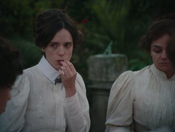 Movie still from “The Electrical Life of Louis Wain” (2021), directed by Will Sharpe – A woman in a white shirt and a woman in a white dress; Medium shot, Over the shoulder angle