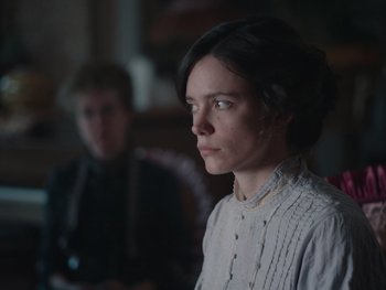 Movie still from “The Electrical Life of Louis Wain” (2021), directed by Will Sharpe – A woman in a white shirt and a man in a black shirt; Close Up shot, Low angle