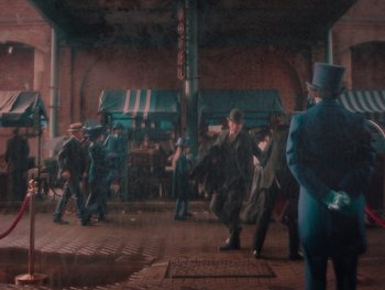 Movie still from “The Electrical Life of Louis Wain” (2021), directed by Will Sharpe – A group of men in suits and hats on a street; Wide shot, High angle