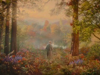 Movie still from “The Electrical Life of Louis Wain” (2021), directed by Will Sharpe – A man standing in a field with flowers and trees; Extreme Wide shot, High angle