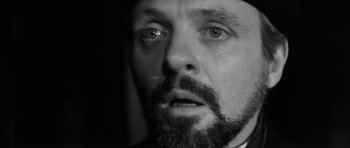 Movie still from “The Elephant Man” (1980), directed by David Lynch – Black and white photograph of a man with a beard crying; Close Up shot, Over the shoulder angle