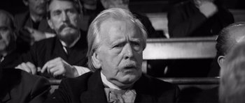 Movie still from “The Elephant Man” (1980), directed by David Lynch – An old man with a beard and a mustache; Close Up shot, Low angle