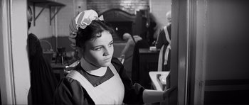 Movie still from “The Elephant Man” (1980), directed by David Lynch – A young woman in a maid's uniform looking at the camera; Close Up shot, High angle