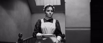 Movie still from “The Elephant Man” (1980), directed by David Lynch – A woman holding a plate in her hands; Medium shot, Low angle