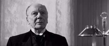 Movie still from “The Elephant Man” (1980), directed by David Lynch – An older man wearing a suit and tie; Close Up shot, Low angle