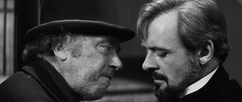 Movie still from “The Elephant Man” (1980), directed by David Lynch – Two men face to face in a black and white photo; Close Up shot, Over the shoulder angle