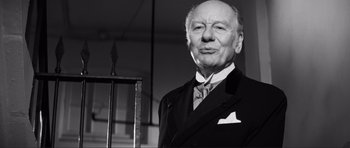 Movie still from “The Elephant Man” (1980), directed by David Lynch – An older man wearing a suit and tie; Close Up shot, Low angle