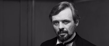 Movie still from “The Elephant Man” (1980), directed by David Lynch – Black and white photograph of a man with a beard; Close Up shot, Over the shoulder angle