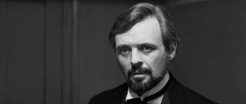 Movie still from “The Elephant Man” (1980), directed by David Lynch – Black and white photograph of a man in a suit and tie; Close Up shot, Over the shoulder angle