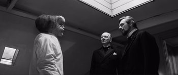Movie still from “The Elephant Man” (1980), directed by David Lynch – A group of men standing next to each other; Medium shot, Low angle