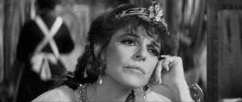 Movie still from “The Elephant Man” (1980), directed by David Lynch – A black - and - white photo of a woman wearing a tiara; Close Up shot, Over the shoulder angle