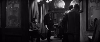 Movie still from “The Elephant Man” (1980), directed by David Lynch – A group of men standing around in a room; Wide shot, Low angle