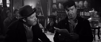 Movie still from “The Elephant Man” (1980), directed by David Lynch – Two men sitting at a table in front of each other; Medium shot, Over the shoulder angle