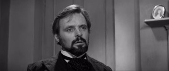 Movie still from “The Elephant Man” (1980), directed by David Lynch – A black and white photo of a man with a beard; Close Up shot, Over the shoulder angle