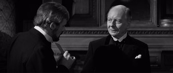 Movie still from “The Elephant Man” (1980), directed by David Lynch – A man in a suit and tie talking to another man in a suit and tie; Close Up shot, Over the shoulder angle