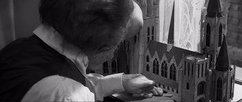 Movie still from “The Elephant Man” (1980), directed by David Lynch – An old man is looking down at a book; Close Up shot, Over the shoulder angle