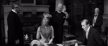 Movie still from “The Elephant Man” (1980), directed by David Lynch – An older man and a woman in period dress; Medium shot, Over the shoulder angle
