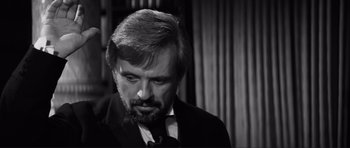 Movie still from “The Elephant Man” (1980), directed by David Lynch – Black and white photograph of a man in a suit; Close Up shot, Over the shoulder angle