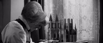 Movie still from “The Elephant Man” (1980), directed by David Lynch – An older woman looking down at a model castle; Close Up shot, Over the shoulder angle
