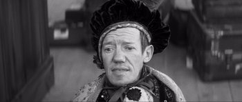 Movie still from “The Elephant Man” (1980), directed by David Lynch – An older man wearing a hat and a cape; Close Up shot, High angle