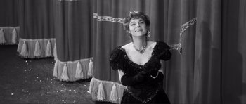 Movie still from “The Elephant Man” (1980), directed by David Lynch – An older woman wearing a black dress and gloves; Medium shot, Low angle