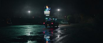 Movie still from “The Enforcer” (2022), directed by Richard Hughes – A truck driving down a street at night; Extreme Wide shot, Low angle