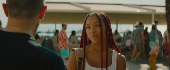 Movie still from “The Enforcer” (2022), directed by Richard Hughes – A young woman with long red braids is looking into the distance; Close Up shot, Over the shoulder angle