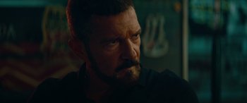 Movie still from “The Enforcer” (2022), directed by Richard Hughes – A person with a beard; Close Up shot, Low angle