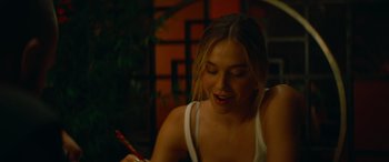 Movie still from “The Enforcer” (2022), directed by Richard Hughes – A woman sitting at a table with a pen in her hand; Close Up shot, Over the shoulder angle