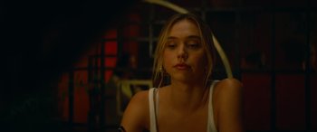 Movie still from “The Enforcer” (2022), directed by Richard Hughes – A beautiful young lady sitting in front of a window; Close Up shot, Over the shoulder angle