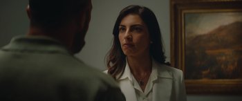 Movie still from “The Enforcer” (2022), directed by Richard Hughes – A woman looking at a man in the mirror; Close Up shot, Over the shoulder angle