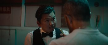 Movie still from “The Enforcer” (2022), directed by Richard Hughes – A man in a tuxedo is looking at himself in the mirror; Close Up shot, Over the shoulder angle