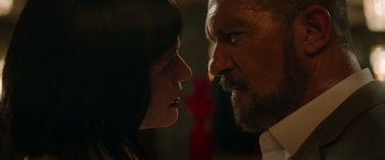 Movie still from “The Enforcer” (2022), directed by Richard Hughes – A man and a woman face to face in the dark; Close Up shot, Low angle
