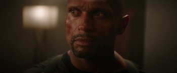 Movie still from “The Enforcer” (2022), directed by Richard Hughes – A man's eyes and face; Close Up shot, Low angle