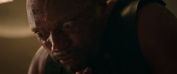 Movie still from “The Enforcer” (2022), directed by Richard Hughes – A man's face in the dark; Extreme Close Up shot, Low angle